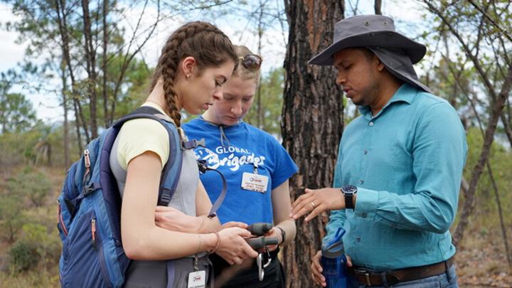 two students being shown object