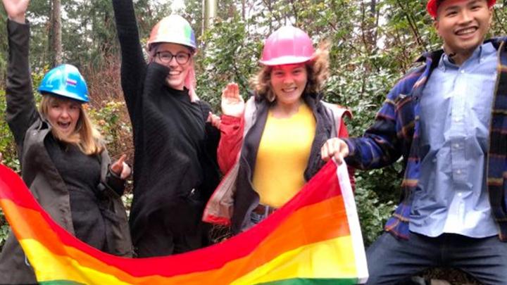 group of students holding pride flag