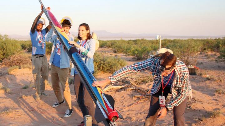 group of students with rocket