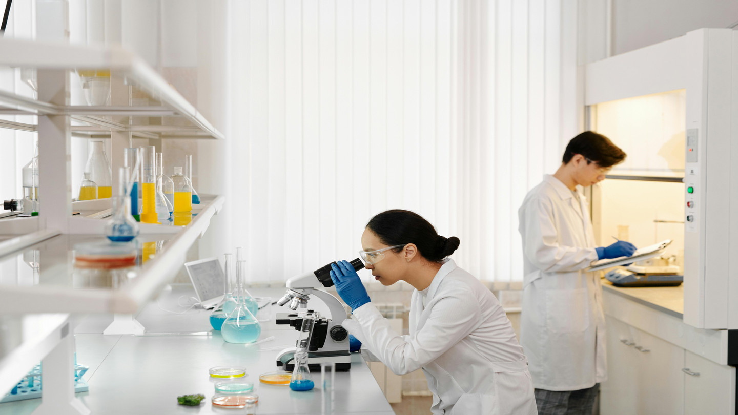 Person looking into a microscope