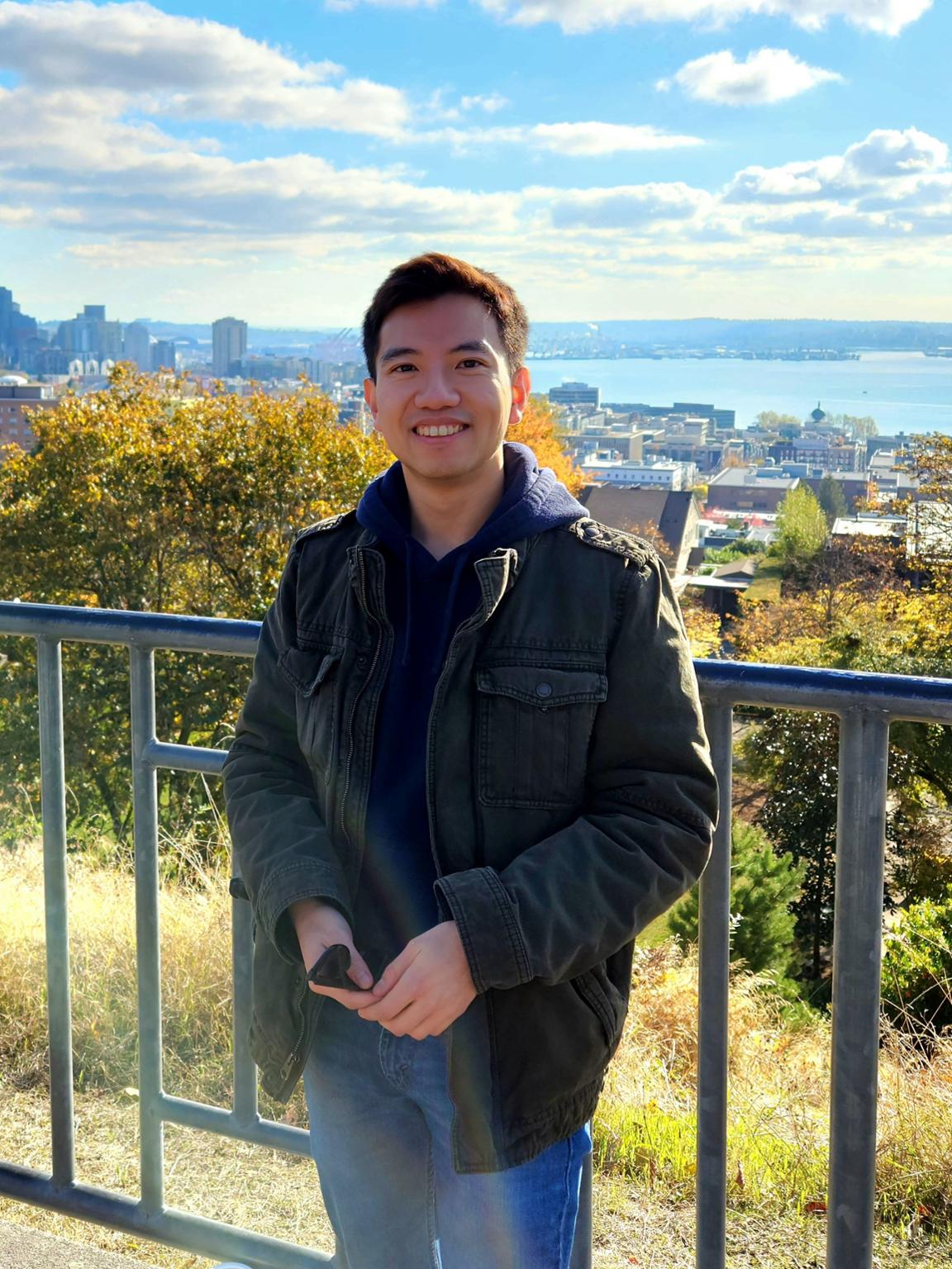 UVic student Jae Park standing in front of a city