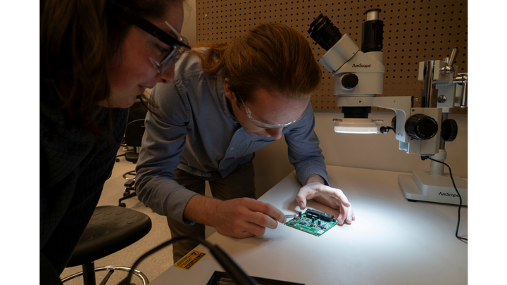 Students soldering in Makerspace.