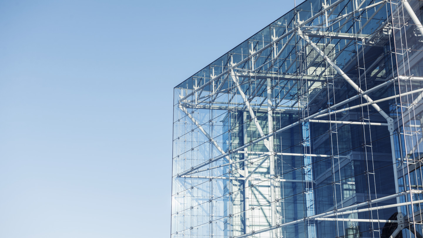 Glass building against a blue sky.