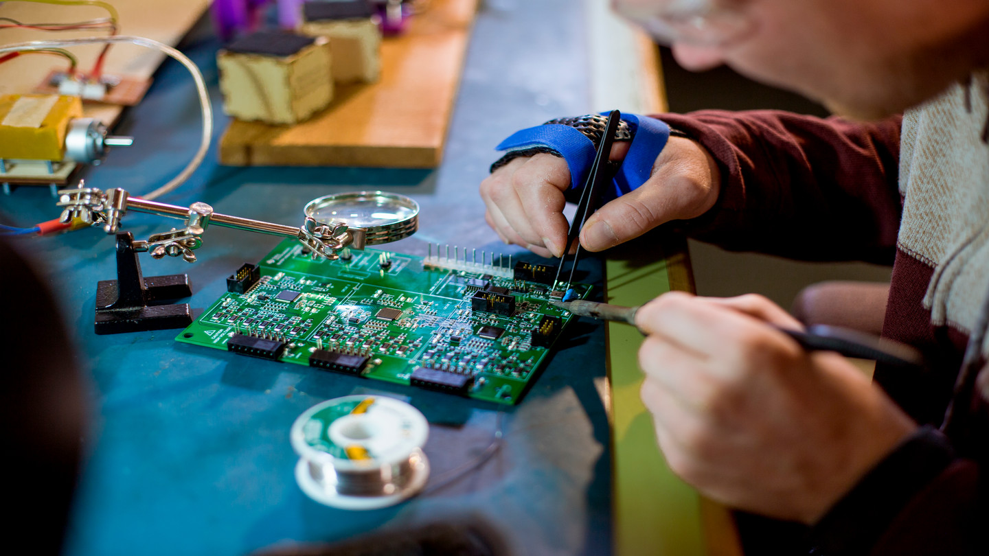 Student soldering circuit board