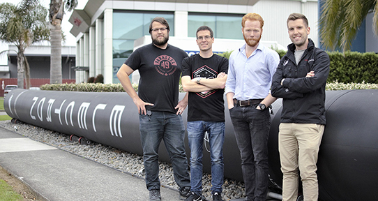UVic engineering grads Cass Hussmann, Michael Pearson, Graeme Ramsay and Simon Moffatt (L-R) are helping Rocket Lab make orbital rockets. Photo: Kieran Fanning.