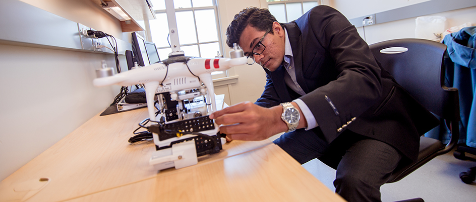 Harsh Rathod working on a drone in his office