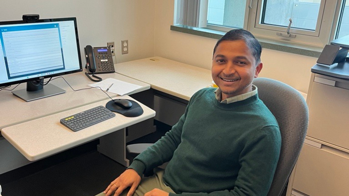 JP Champati sitting in his office in front of a computer.