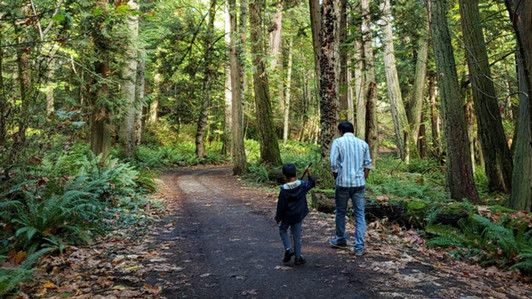 A father and son walk through PKOLS forest as part of the Generation Health project.