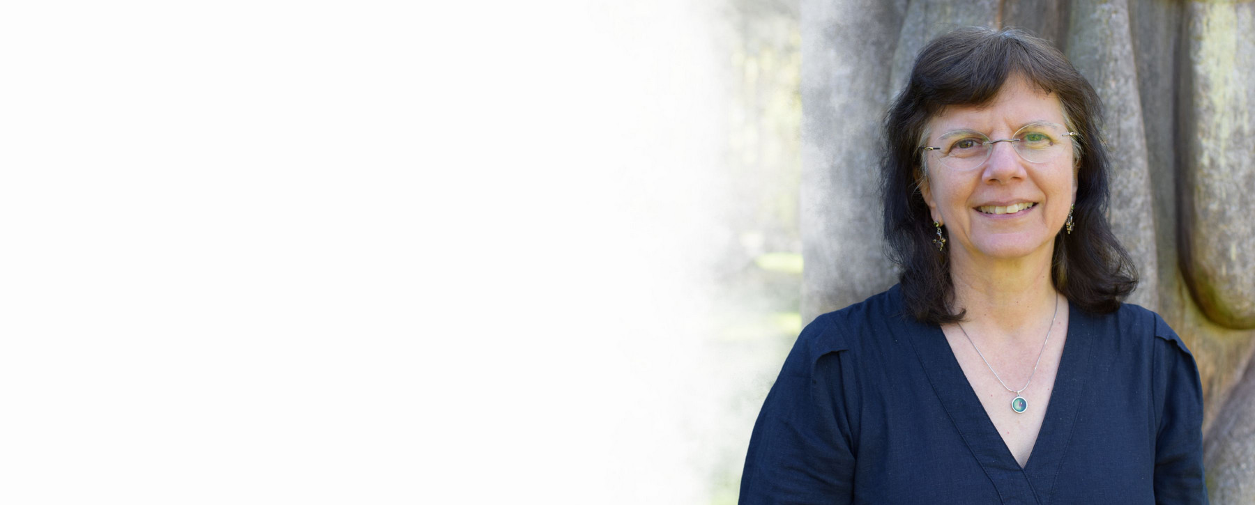 A portrait of Dr. Anita Prest outdoors on campus at UVic on a sunny day.