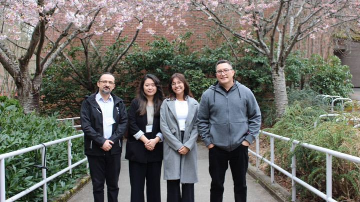 Four members of the AGES committee are pictured outside the MacLaurin building in Spring 2023.