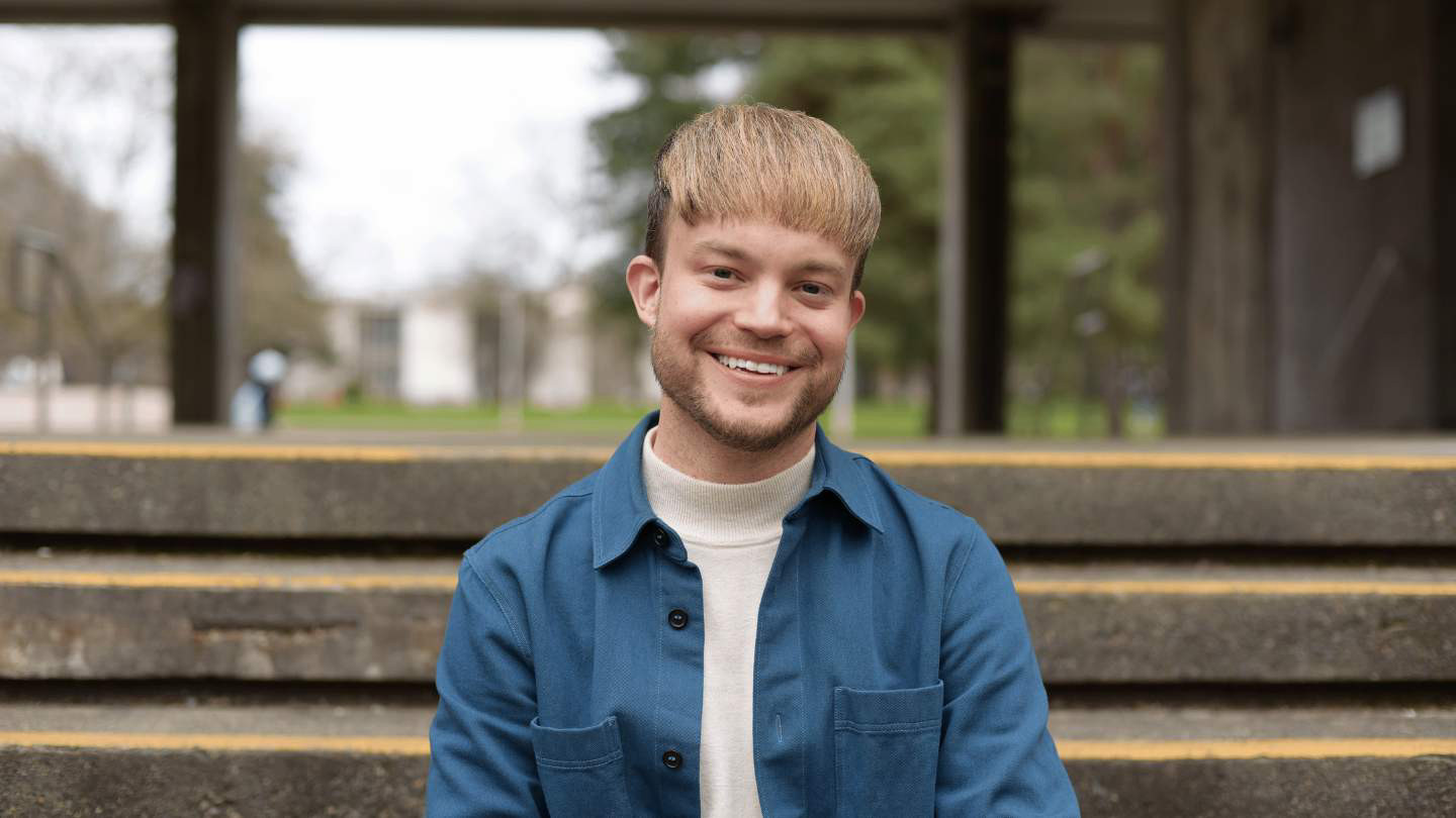 A portrait of Jon Woodend, he is pictured outside the MacLaurin Building.