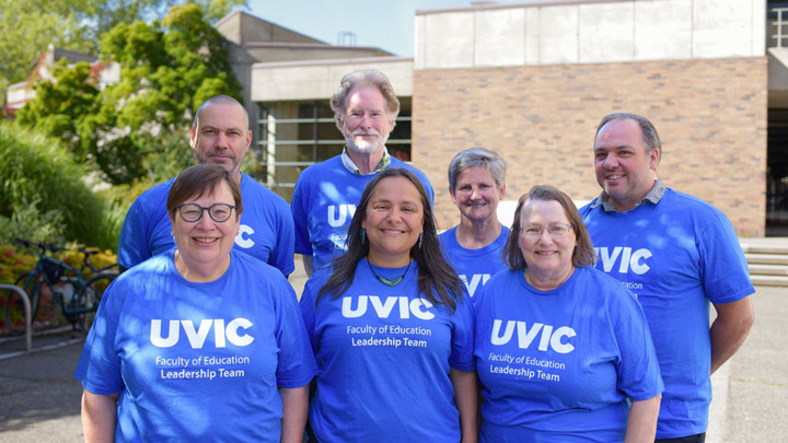 A group photo of the Faculty of Education leadership team (Deans and Chairs), pictured together outside the MacLaurin Building on campus.