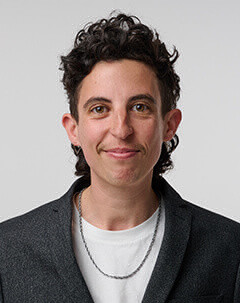 Headshot of LJ Slovin in front of white background.