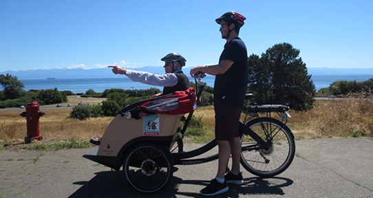 Student cycling with a senior citizen