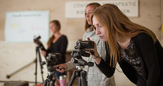 Amber Nordquist looking through a video-recorder