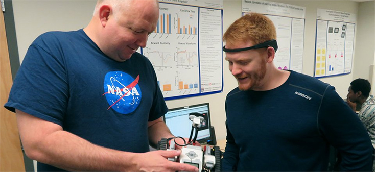 Olav Krigolson and Chad Williams looking at their Lego Mindstorm car