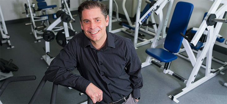 Ryan Rhodes in a gym with a test subject