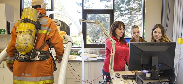 Lynneth Stuart-Hill and her students carrying out testing on a firefighter in the lab