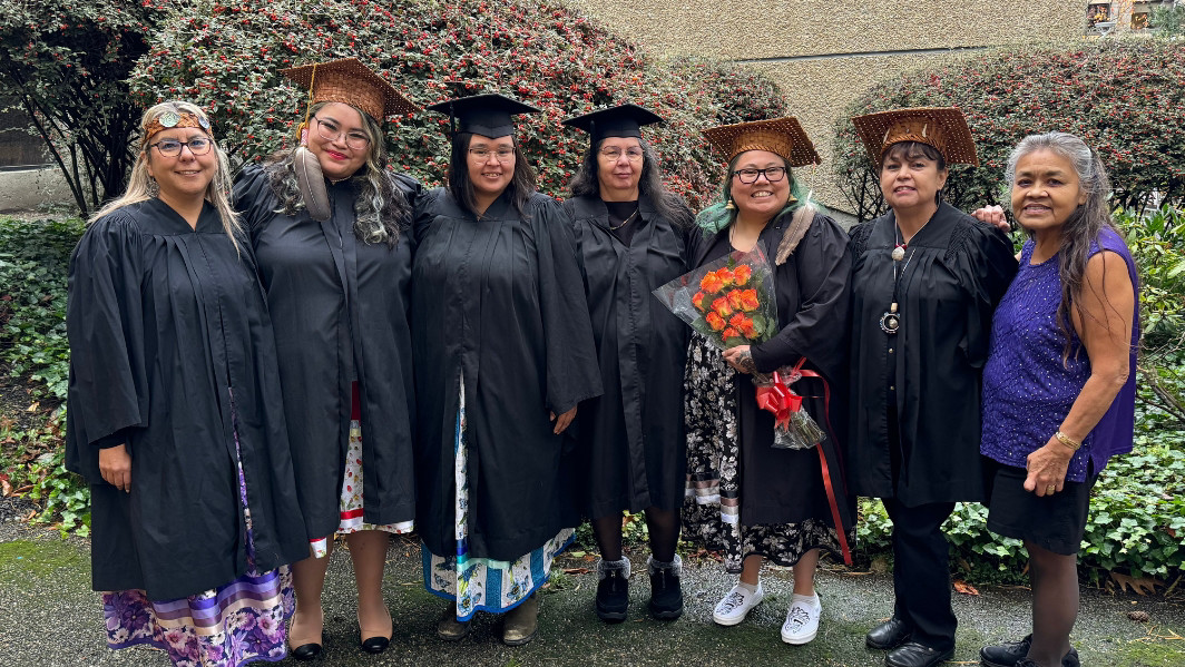 A group of DILR graduates are pictured together on campus on graduation day.