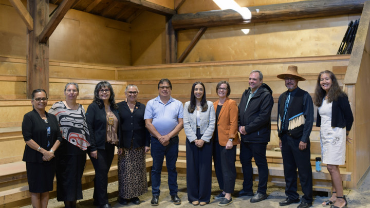 A group of partners from UVic, the Ministry, FNESC, and Stz'uminus First Nation gather together to acknowledge the funding announcement in Stz'uminus Big House.