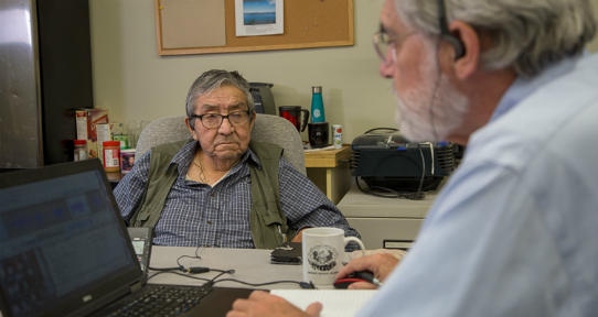 Lou Claxton and Timothy Montler working together at a computer