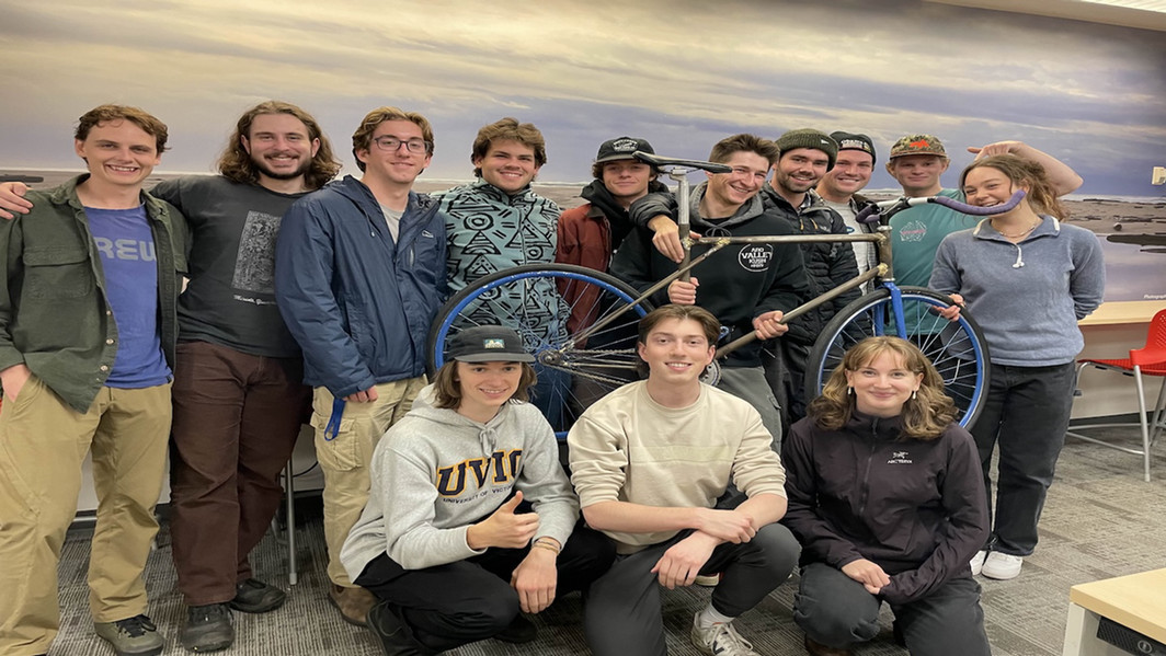 BDAM club standing with one of their bikes.