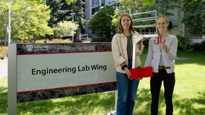 two students holding biomedical equpment