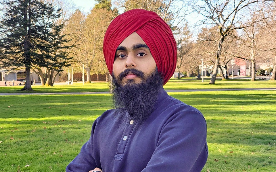 Kawaljit Singh was one of three UVic students named 2020 Co-op Students of the Year Singh stands outside on campus, with trees and buildings in the background.