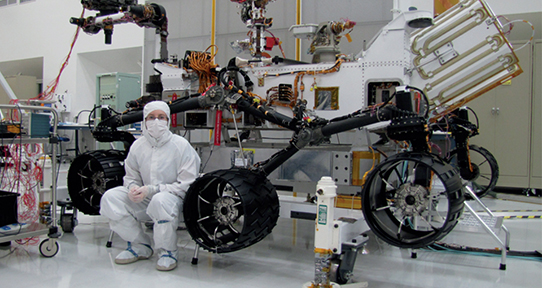 Cambria Logan might have never been to space, but her years of hard work helped send the Curiosity Rover on a successful mission to Mars (she is seen here tests on the sampling system of the rover in the Spacecraft Assembly Facility at the Jet Propulsion Laboratory). Photo: Matt Horner.