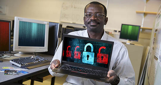 Issa Traoré holding a laptop