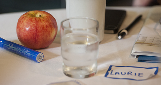 Workshop table with an apple and pens