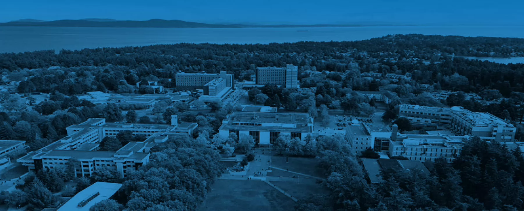 An aerial photo of the UVic campus with a blue overlay.