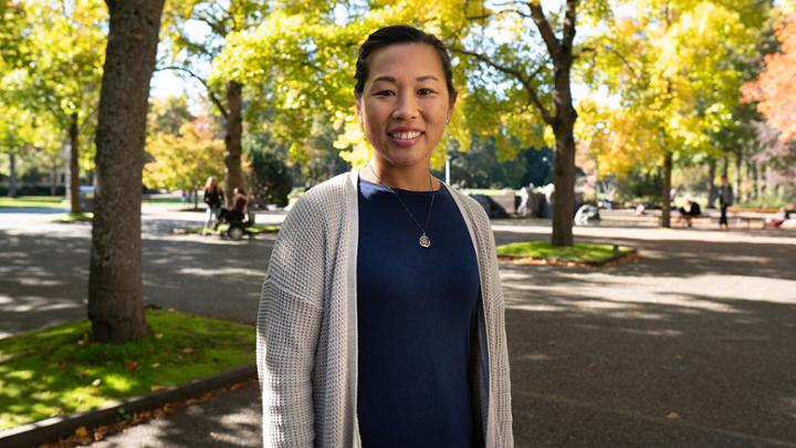 Smiling woman on UVic campus quad