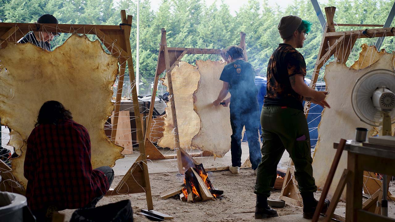 Students learning traditional Indigenous hide-tanning techniques