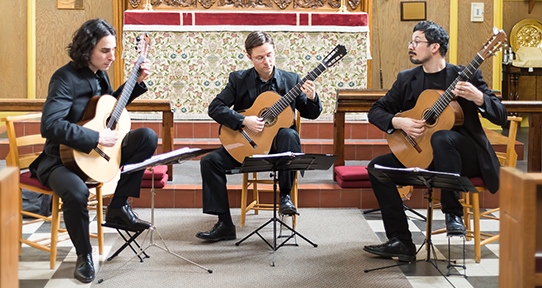 Adrian Verdejo, Michael Dias and Bradford Werner playing guitars