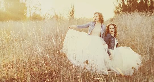 Carli and Julie Kennedy in a field with tall grass