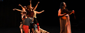 Five students on stage during a performance