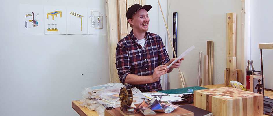 Male student at a woodworking desk in a workshop