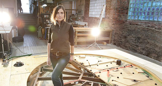 Artist and alumna Marla Hlady in her studio with her sculpture on the floor