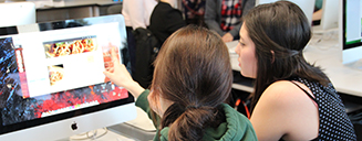 Two students looking at a computer screen