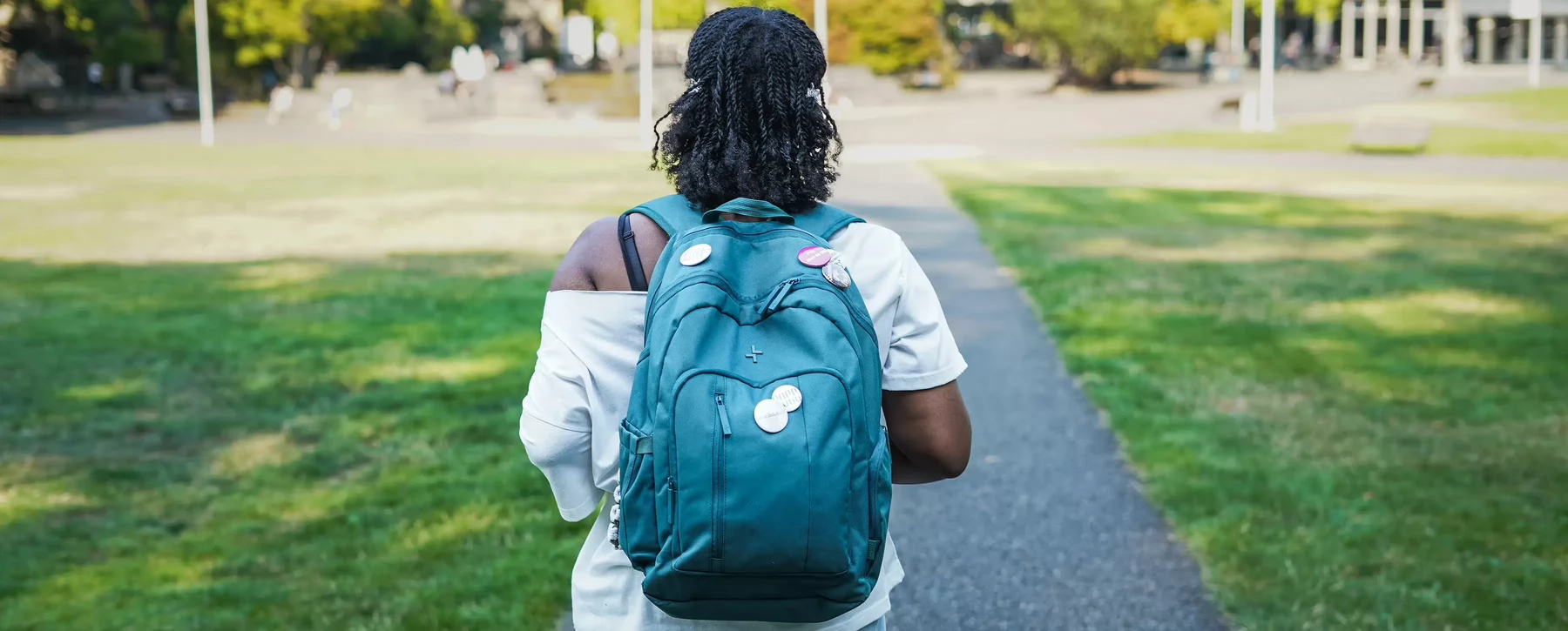 Roven walking with her backpack on UVic campus