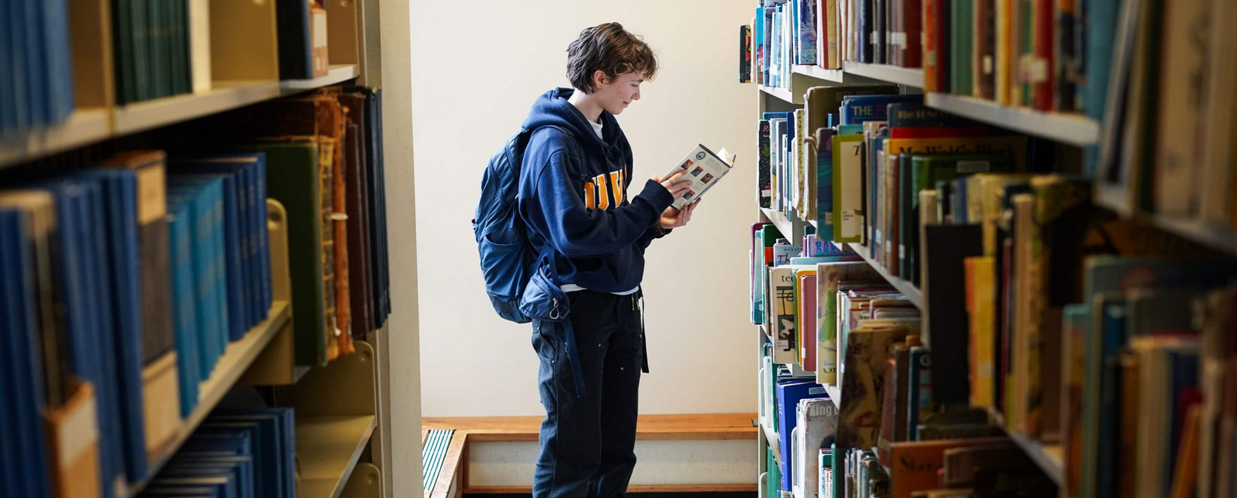Anya reading a book in the UVic library