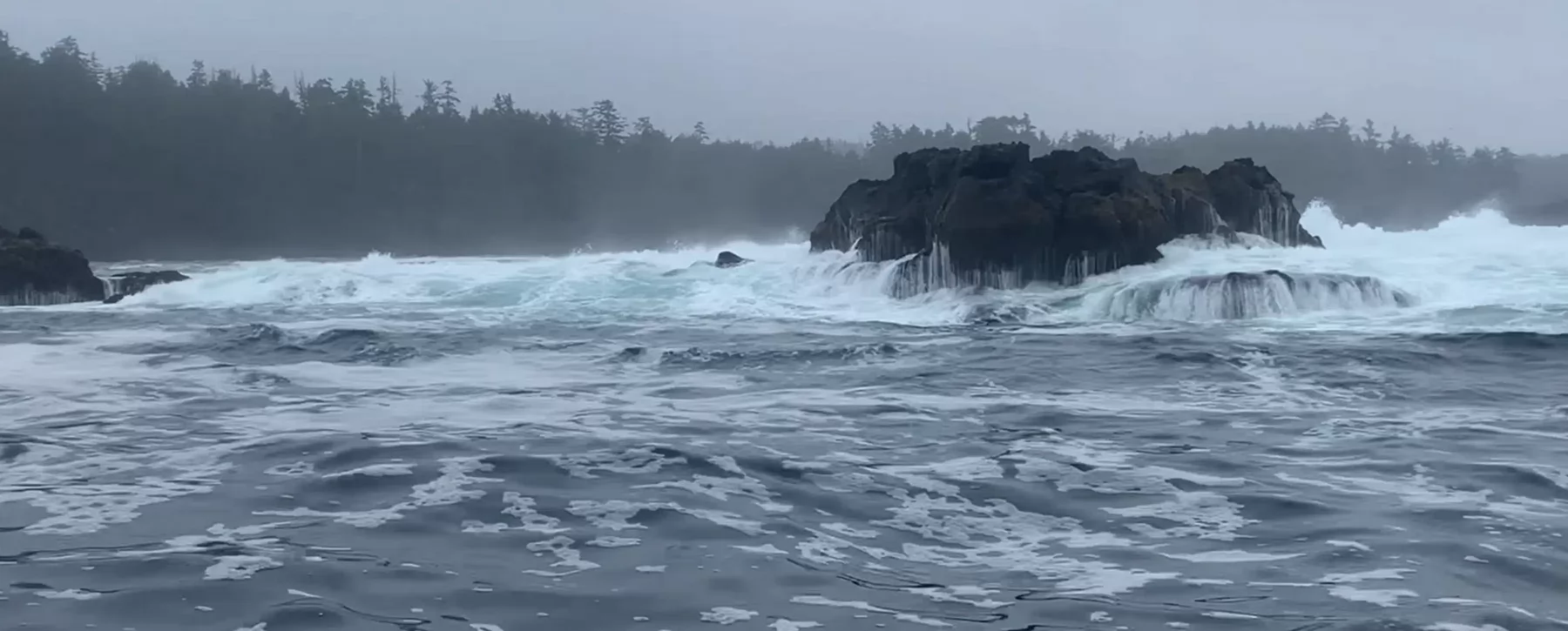 Waves crashing against a rocky shore. 