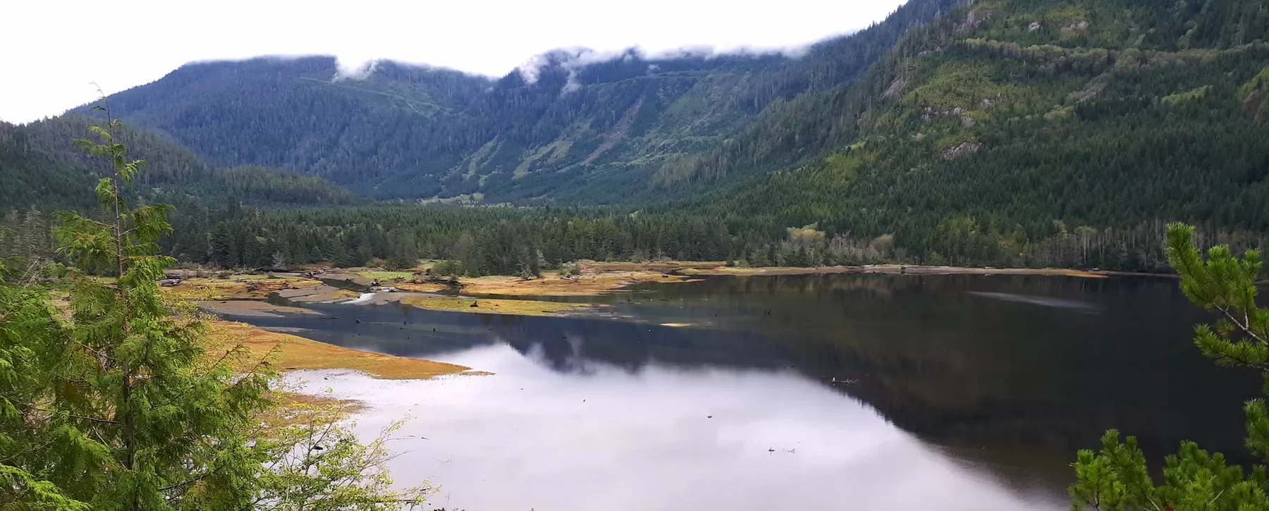 A river estuary with a mountain in the background.