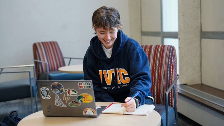 Anya studying at table in UVic library