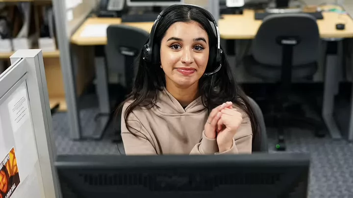 A student in the call centre wearing a headset