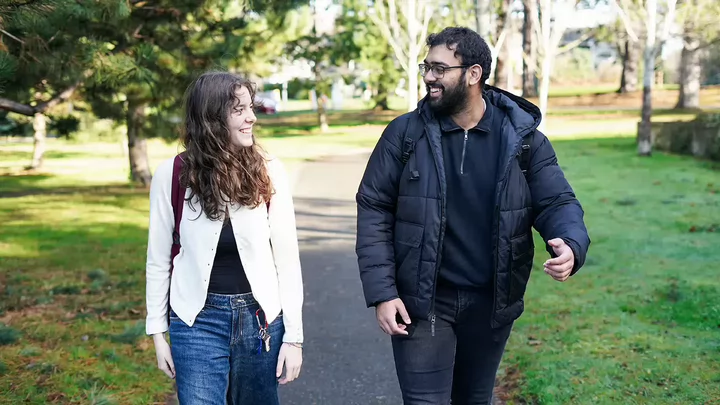  Charlotte Davidson and Fawzan Hussain walk across campus.