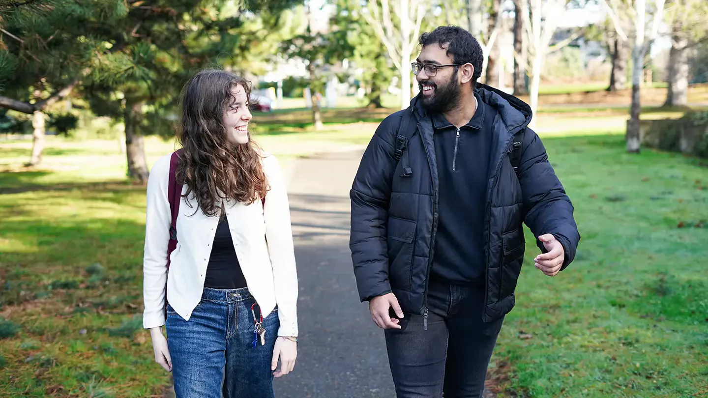  Charlotte Davidson and Fawzan Hussain walk across campus.
