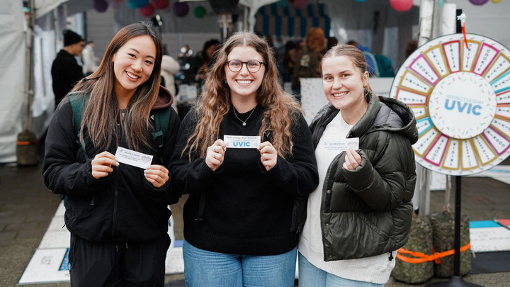 Students smiling outside the Giving Tuesday tent