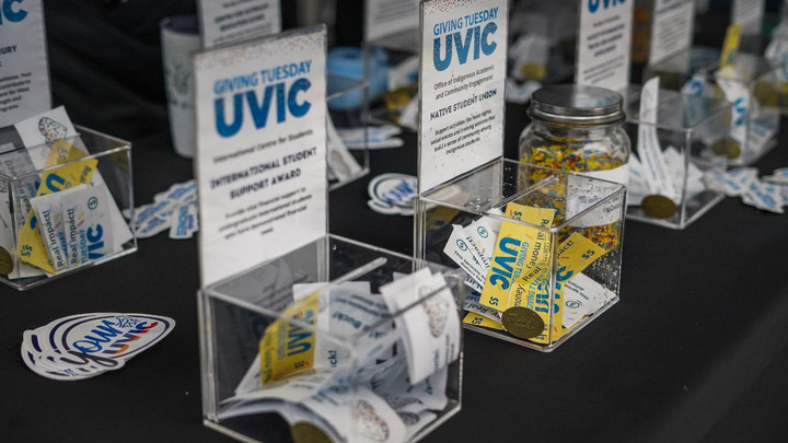 Sprinkle buck filled donation boxes on table